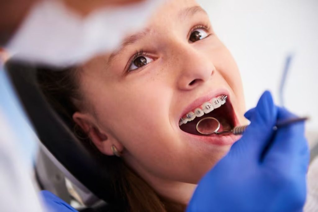 teen patient with braces during a routine orthodontic checkup and dental examination